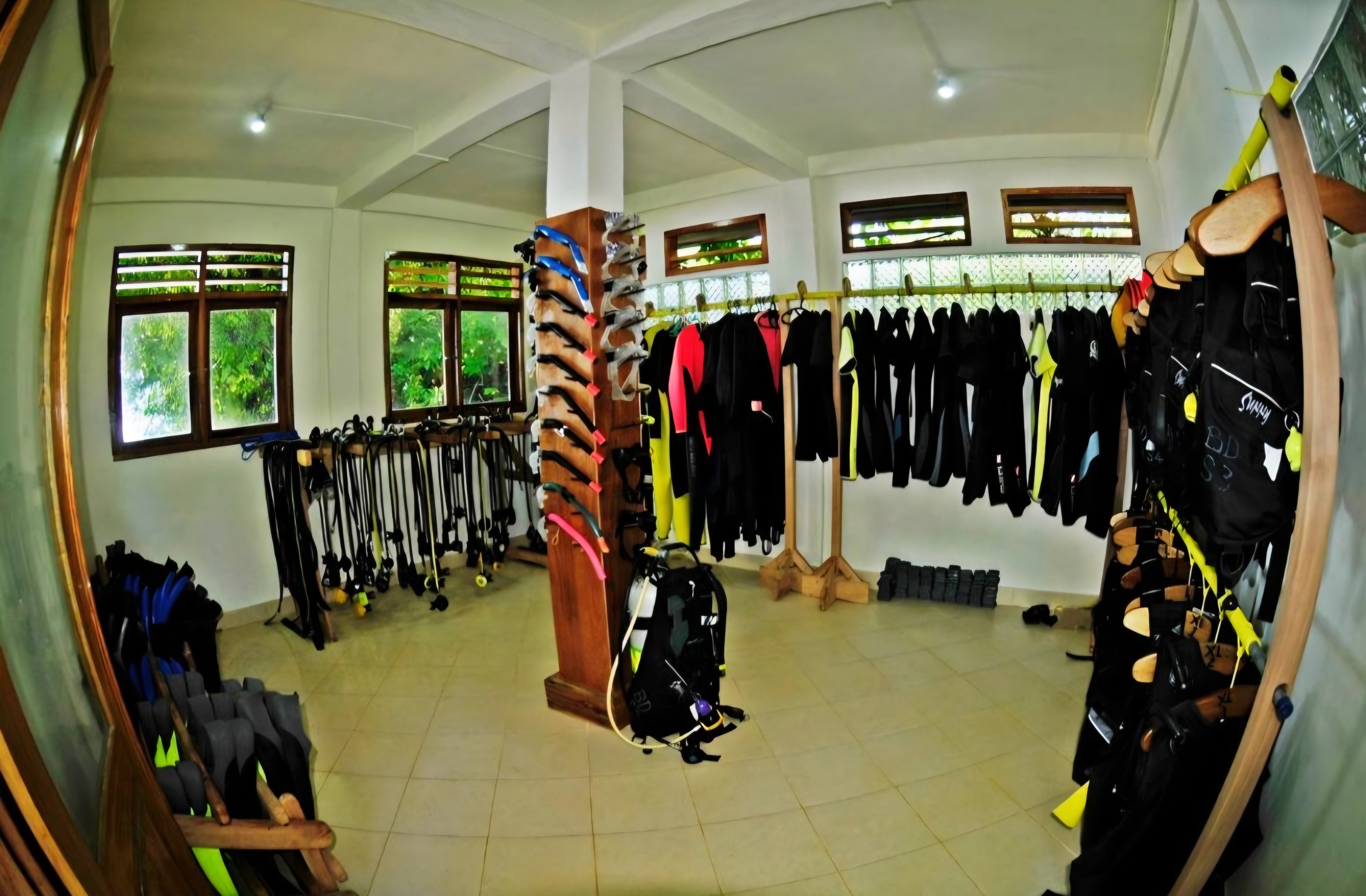 Fully stocked equipment room with wetsuits, fins, masks and BCDs ready for guests