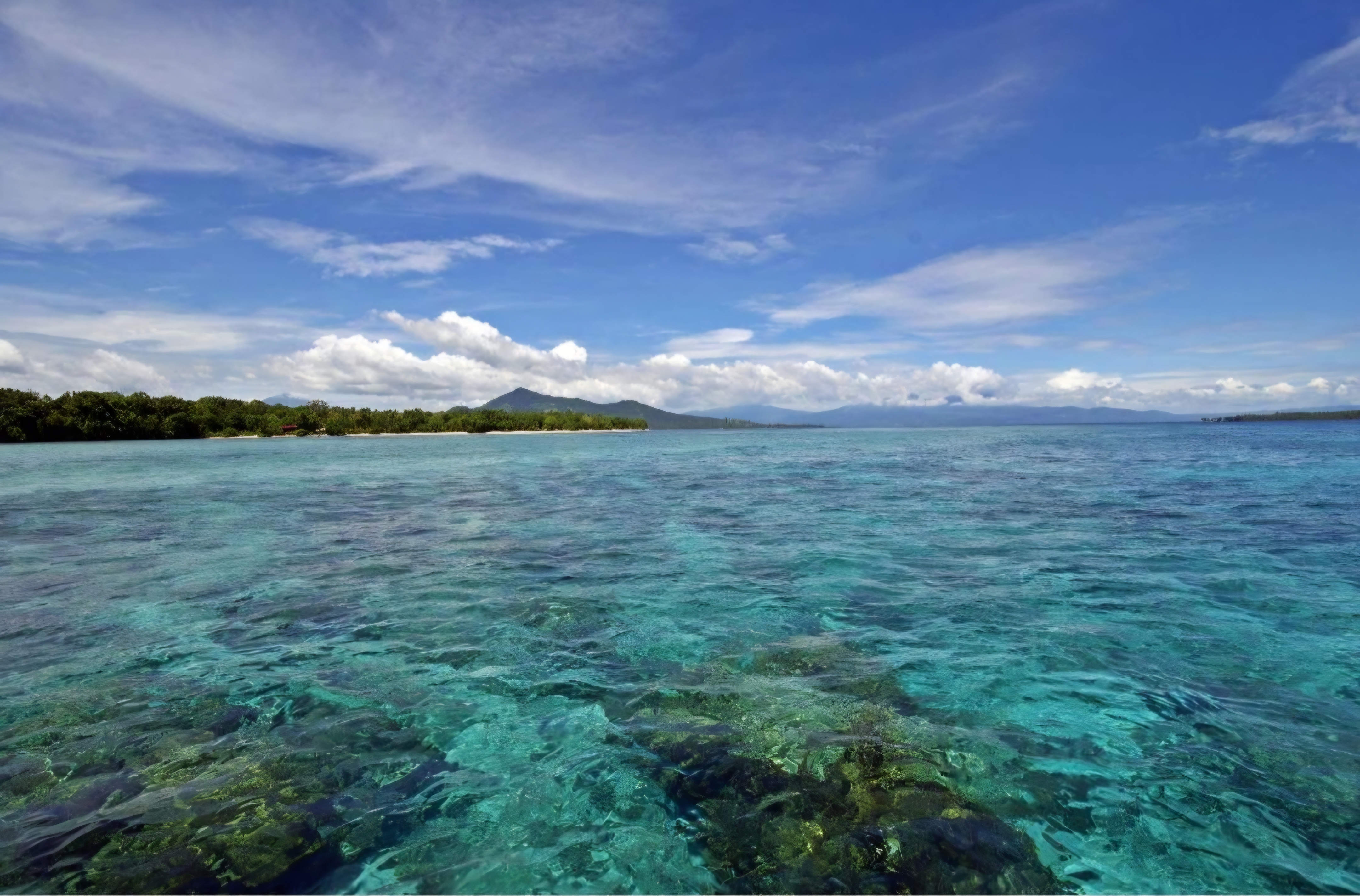 Clear turquoise water over the reef looking toward Manado Tua